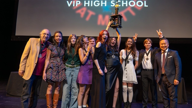 Councilmember Lee celebrating with students from VIP High School on stage at the Soraya.